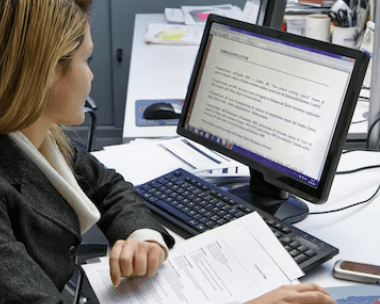 Certified Farsi transcription expert carefully transcribing legal documents, ensuring accuracy for customer satisfaction.