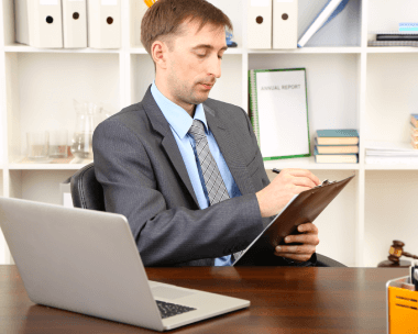 Translator working on a laptop, representing advanced technical features for high-quality Spanish transcription services 