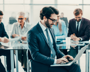 Professional working on a laptop, comprehensive post-delivery support and adherence to industry compliance standards.